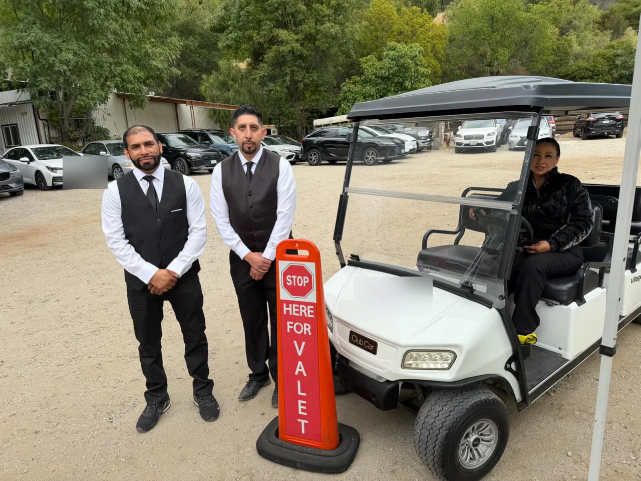 A&A Parking Services attendants with a guest transport cart at an event site
