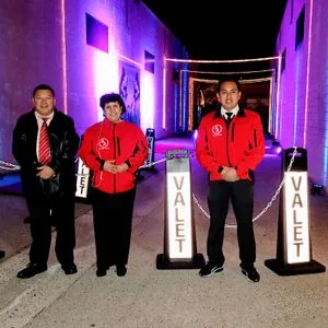 Uniformed valet attendants at an elegant nighttime event