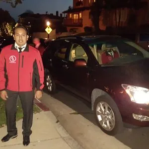 Valet attendant returning a vehicle at a nighttime event