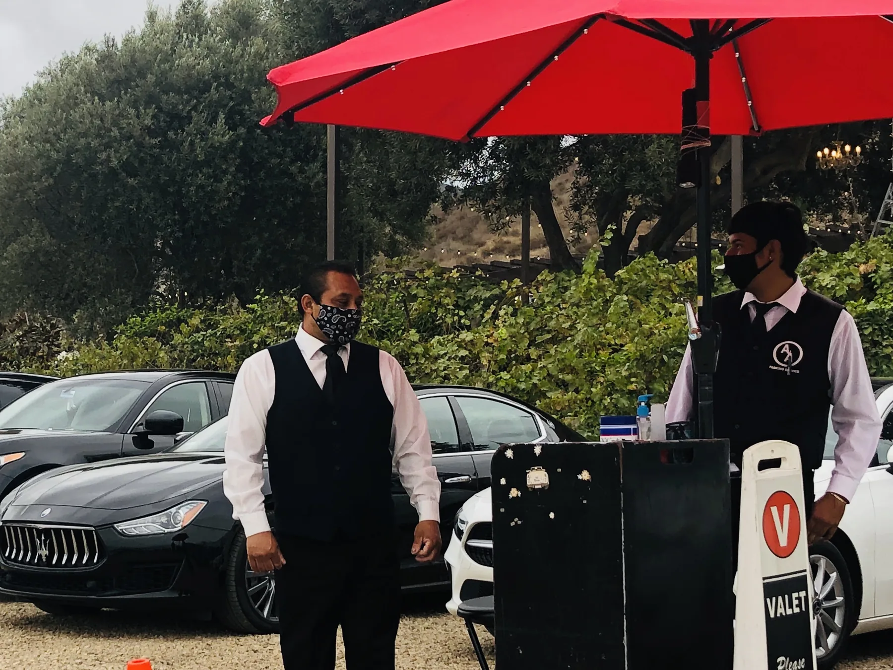A&A Parking Services valet attendants beside a black Maserati at a private estate wedding