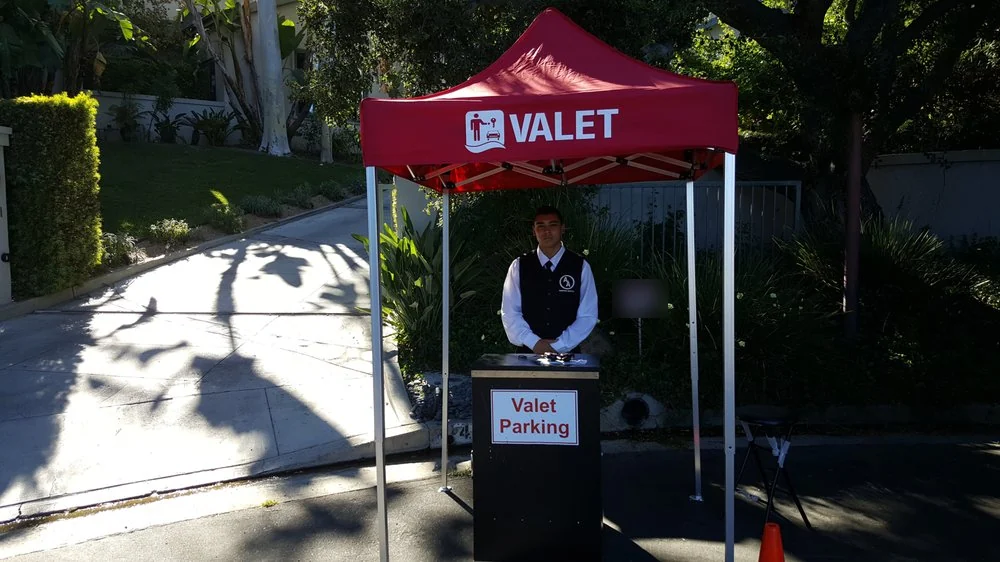 A&A Parking Services branded red valet tent and attendant at the driveway of a private home in Los Angeles County