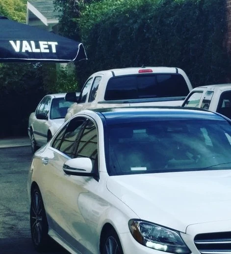 A&A Parking Services branded VALET umbrella and guest cars staged in a private driveway in Los Angeles County