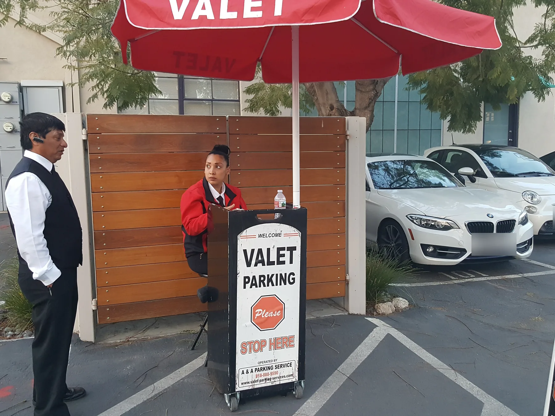 A&A Parking Services valet stand with company signage and uniformed attendants on site