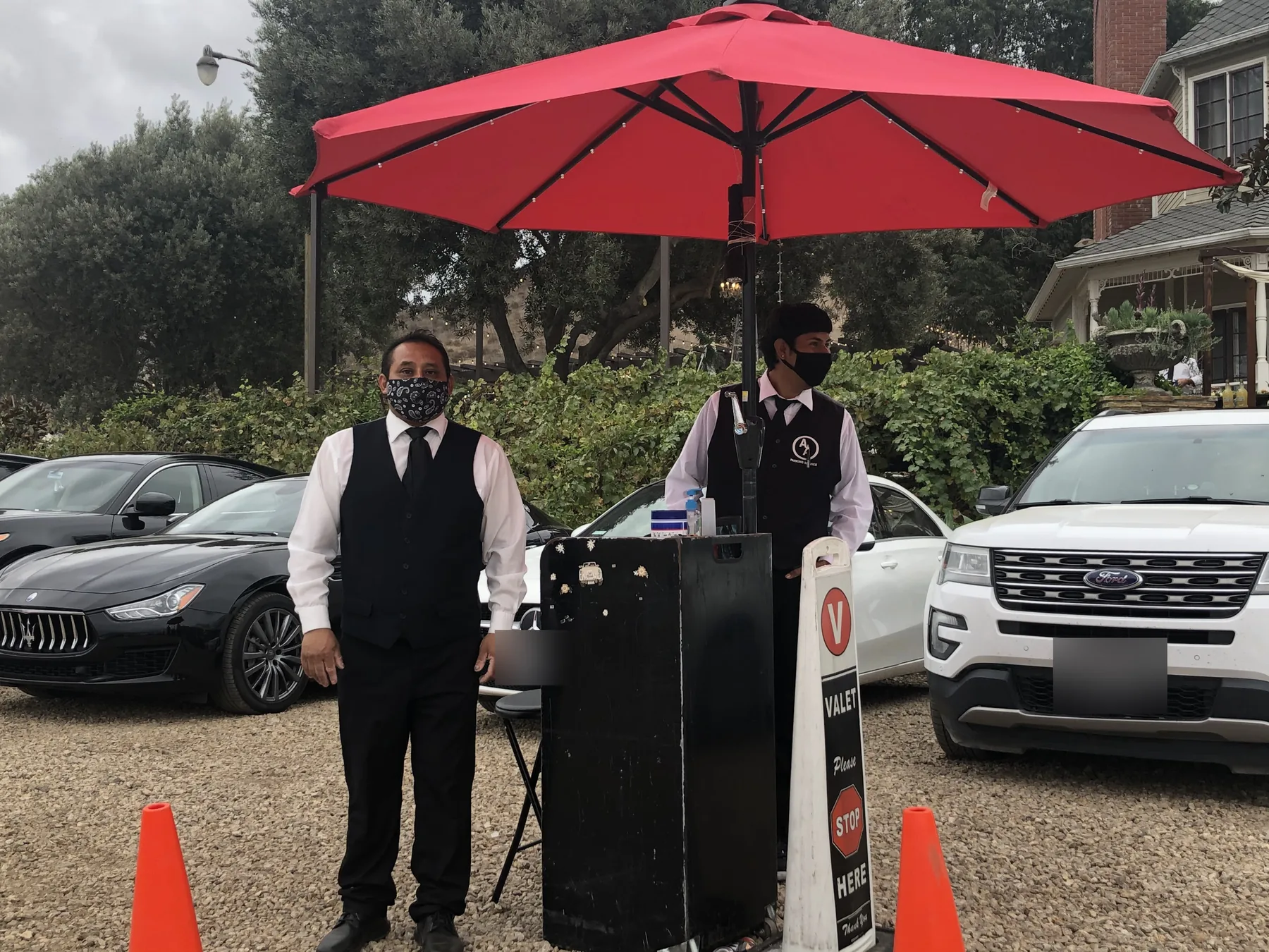 A&A Parking Services valet stand with red umbrella at a private estate wedding