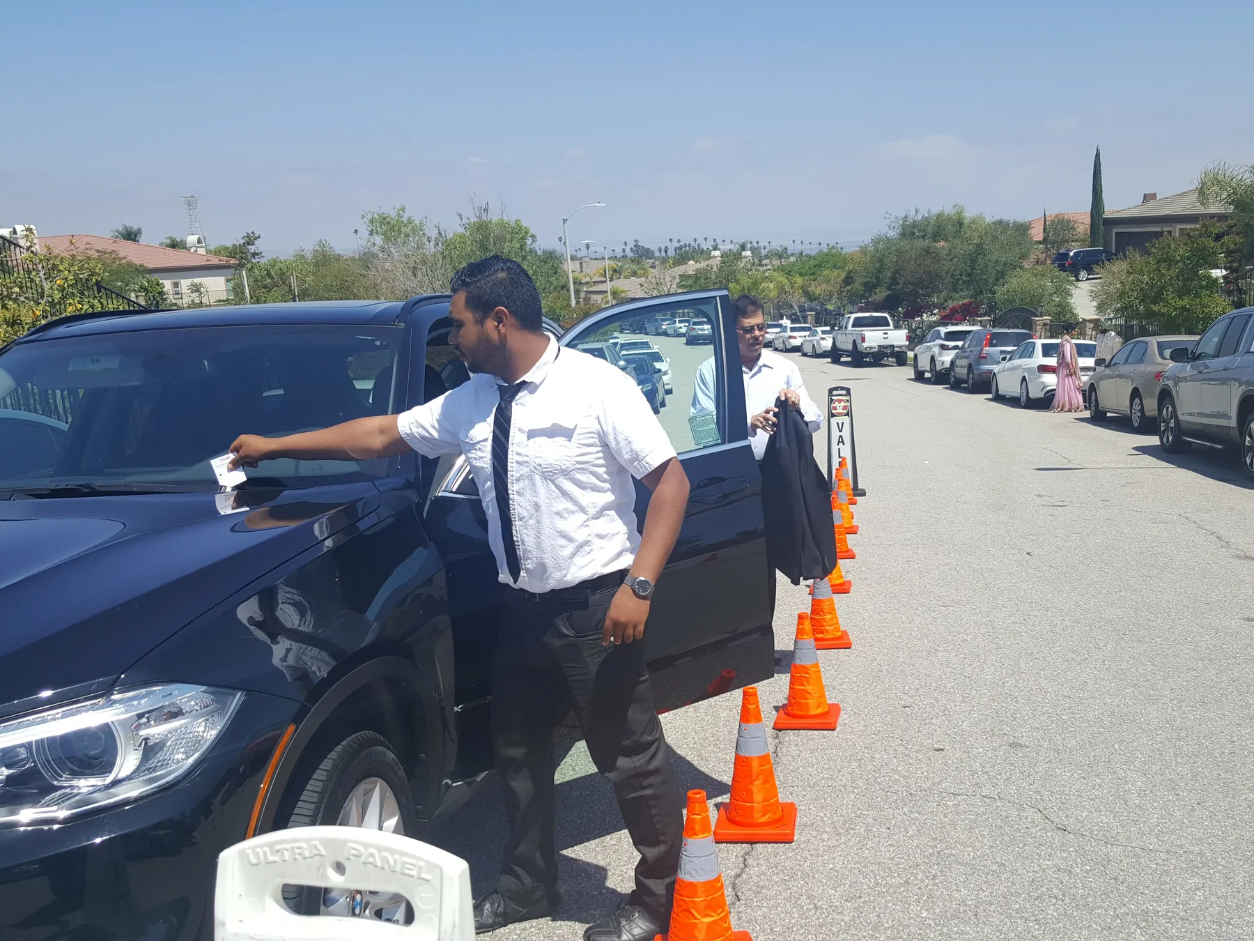 A&A Parking Services valet placing a claim ticket on a guest vehicle at an event arrival