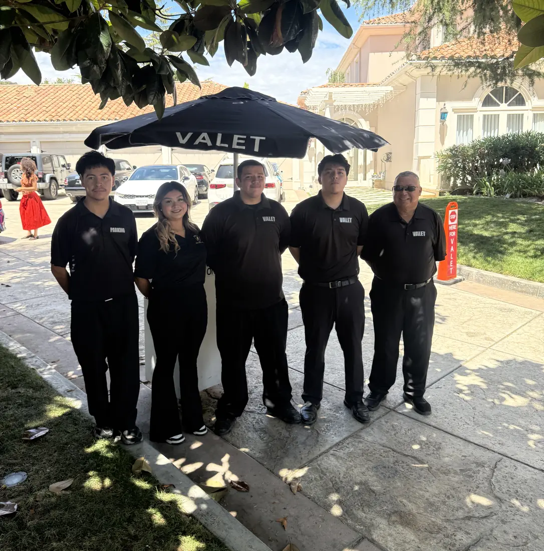 A&A Parking Services valet team under a branded VALET umbrella at a private mansion in Montecito